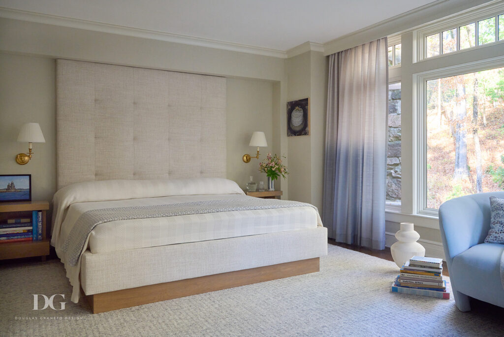 Bedroom looking out at woodland. Large full height upholstered custom headboard